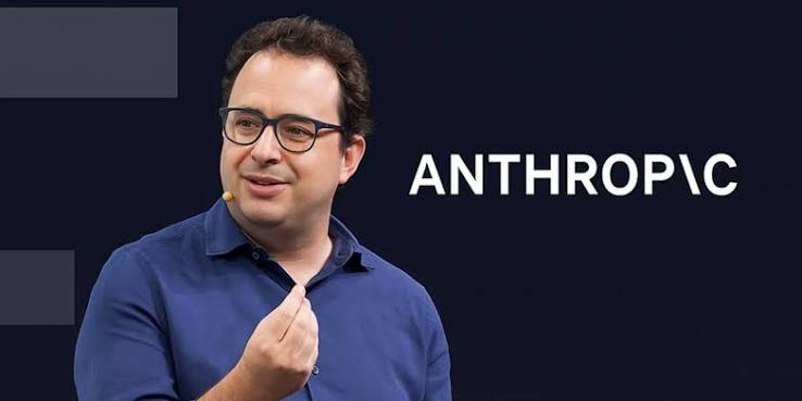 A speaker on stage in front of the Anthropic logo